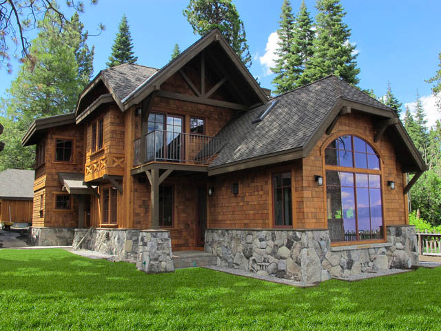 A two-story wooden cabin with stone accents sits amidst lush greenery and tall trees in Madison, WI. The house, recently updated with exterior renovations, boasts a steeply pitched roof, large windows, and a small balcony. In the backyard, you'll find neatly manicured grass under a sky dotted with scattered clouds.